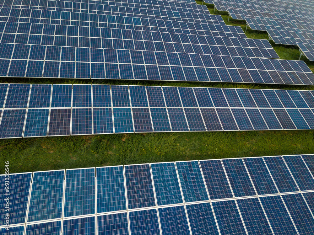 Aerial view of solar panels in solar farm for green energy taken from drone Aerial view of solar panels in solar farm for green energy taken from drone