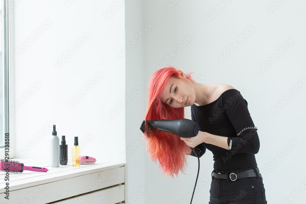 Hairdresser, beauty salon and people concept - young woman hair stylist with hair dryer on white background Hairdresser, beauty salon and people concept - young woman hair stylist with hair dryer on white background