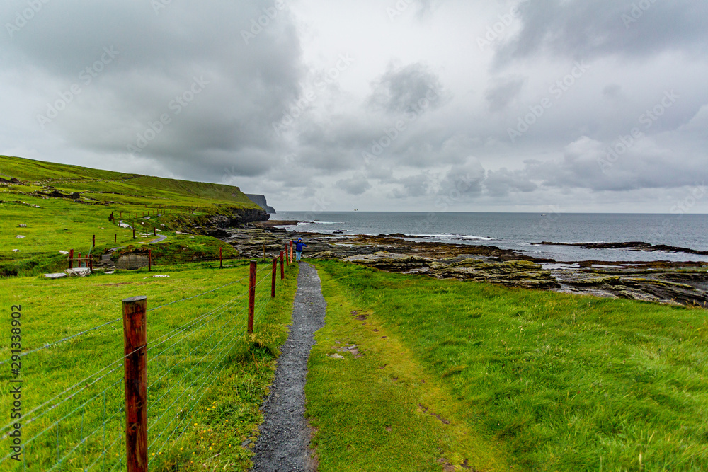 Rural path from Doolin to the Cliffs of Moher along the spectacular coastal route walk, geosites and geopark, Wild Atlantic Way, spring day in County Clare in Ireland