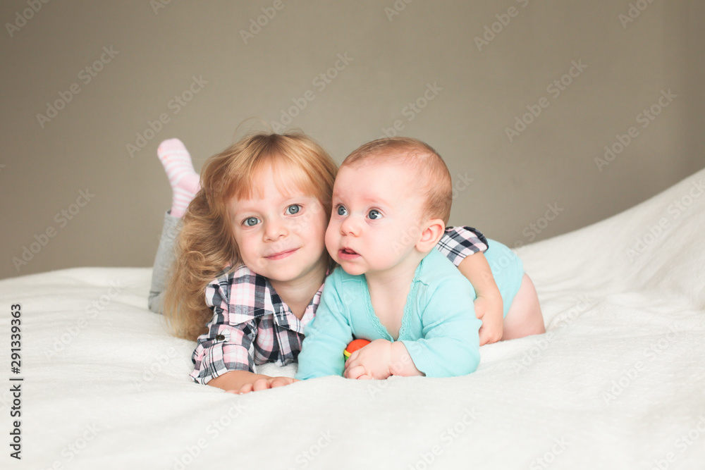 Two Beautiful sisters playing together, One 3 Years Old Toddler Girl and 6 month old Baby Girl Two Beautiful sisters playing together, One 3 Years Old Toddler Girl and 6 month old Baby Girl