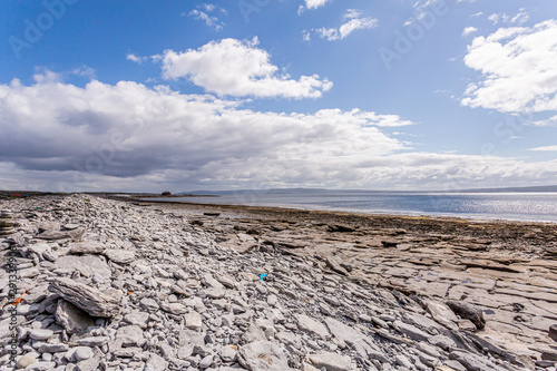 Empty limestone rocky beach of the island of Inis Oirr with the Atlantic Ocean and the Plassey shipwreck in the background  Inisheer is a small island in the west of the coast of Ireland