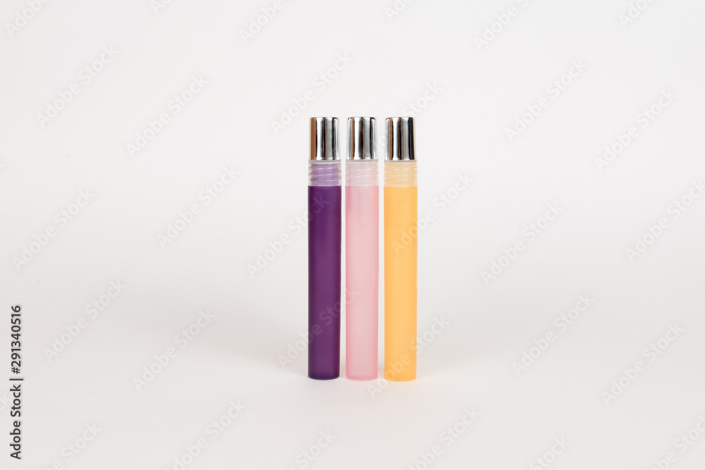 Obraz premium colorful matte narrow high perfume bottles set on a white background