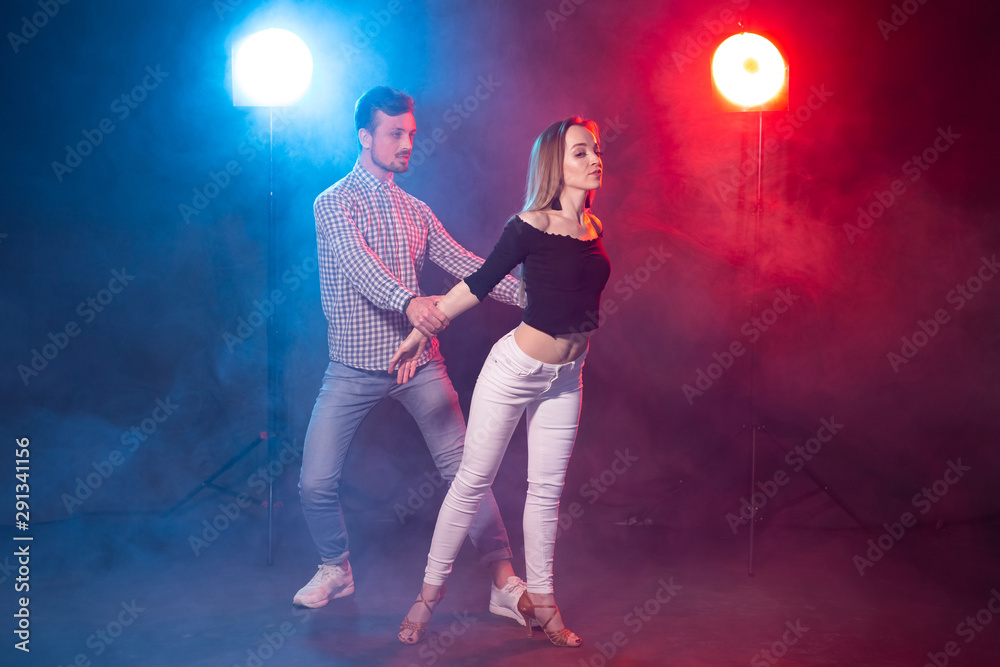 Social dance, kizomba, salsa, semba or zouk concept - a young couple dancing bachata and salsa at the disco Social dance, kizomba, salsa, semba or zouk concept - a young couple dancing bachata and salsa at the disco
