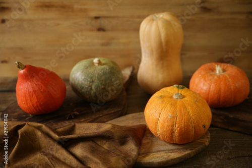 orange pumpkin and gourds and slice of pumpkin on the wooden rustic table. Thanksgiving Day. Halloween. Harvest. Autumn still life