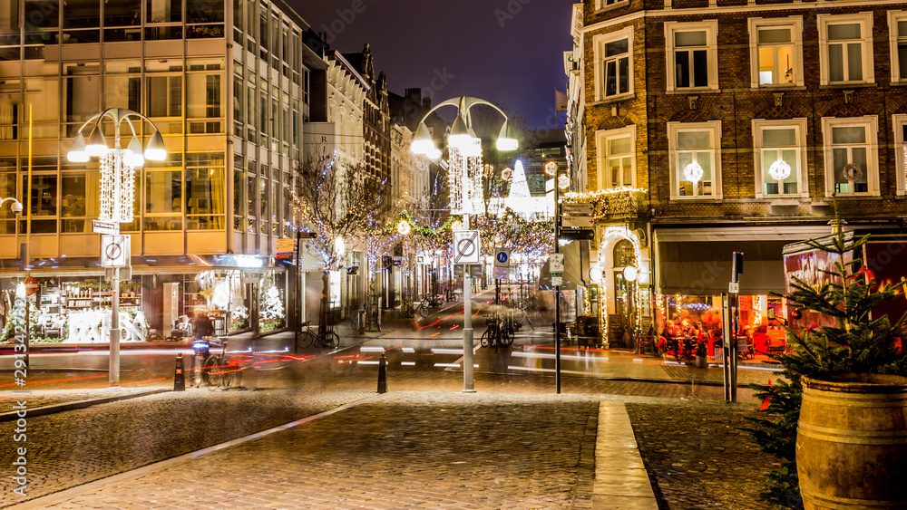 Cobbled street with pole lamps decorated with white lighting, Christmas decorations on a calm cold winter night in Maastricht, South Limburg in the Netherlands Holland Europe