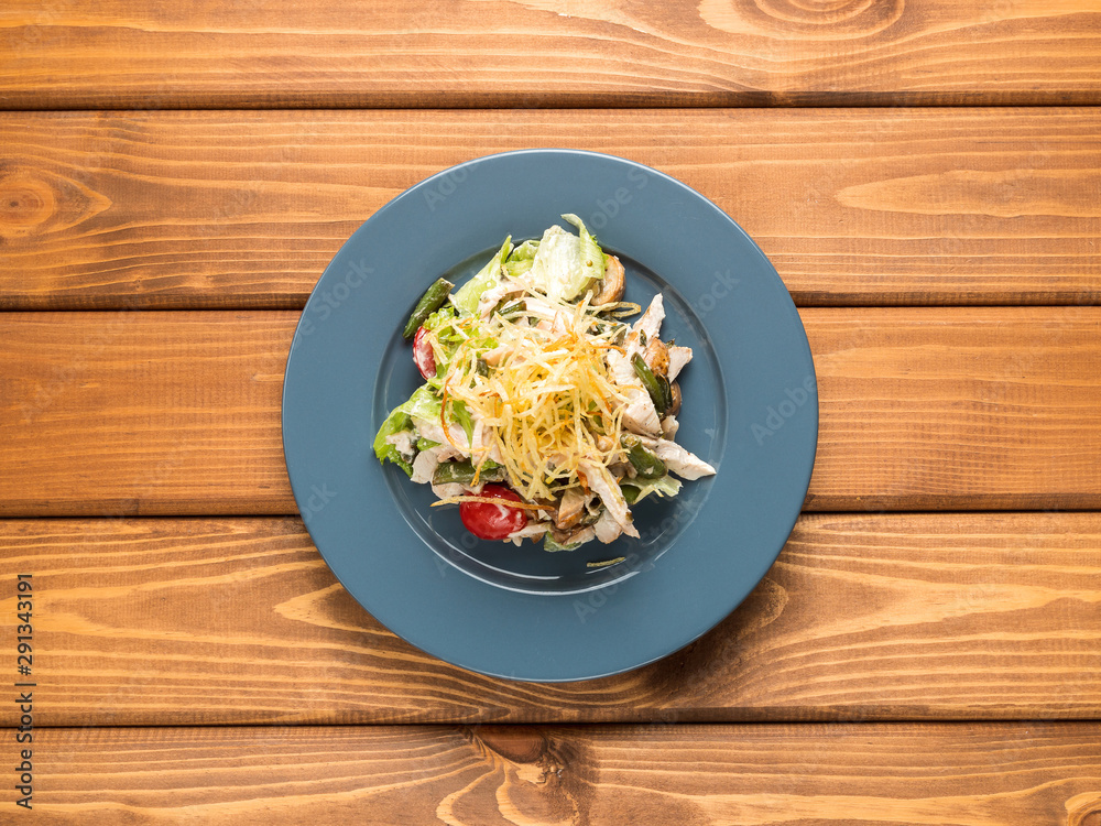 Salad chiken, tomatoes and herbs on a wood background Salad chiken, tomatoes and herbs on a wood background