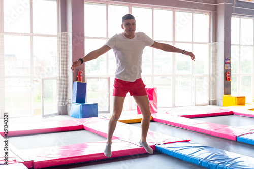 Leisure, sports games and interests - Funny young man trampolining in fly park