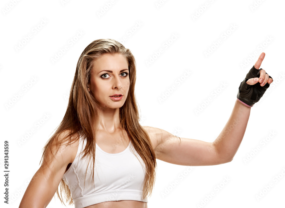 Portrait of fit athletic woman bodybuilder pointing away Portrait of fit athletic woman bodybuilder pointing away
