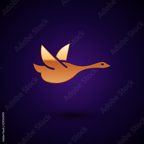 Gold Flying duck icon isolated on dark blue background. Vector Illustration