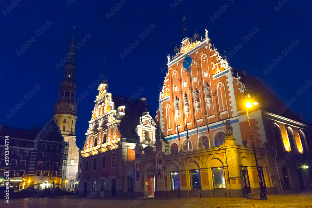 central square in Riga and House of Blackheads in the old town at night in Riga, Latvia...