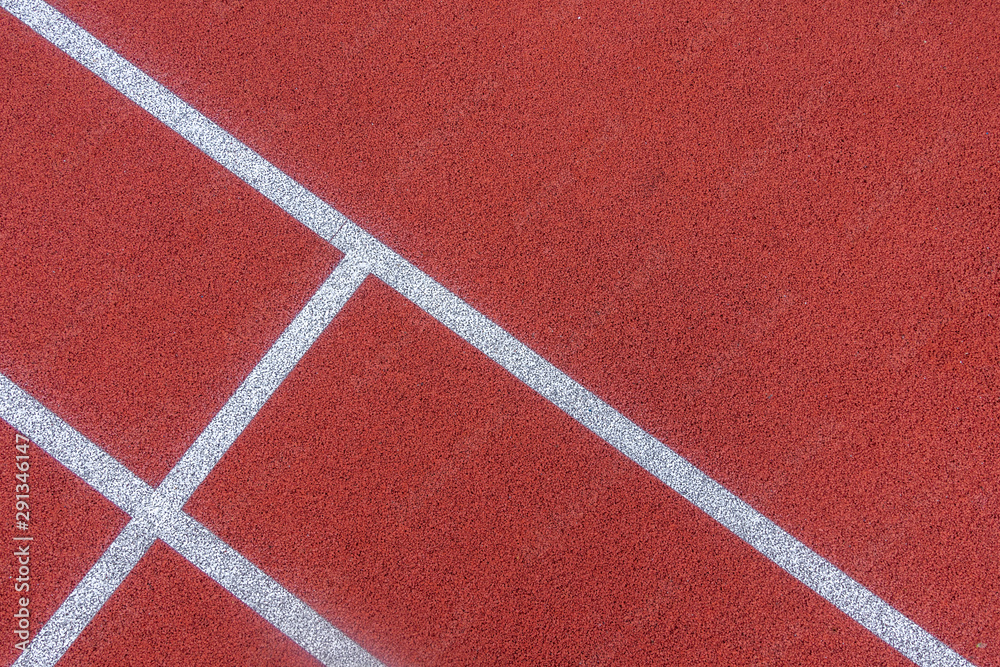 Colorful sports court background. Top view to red field rubber ground with white lines outdoors