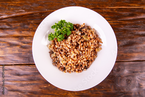 Seeds of buckwheat cereal with fried mushrooms and onions with parsley