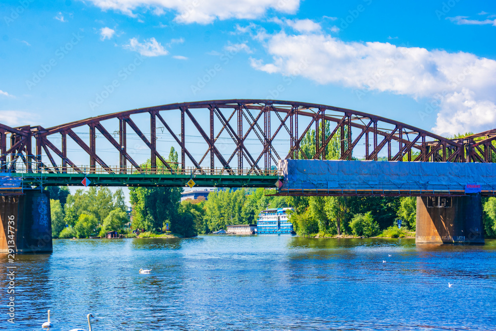 Fototapeta premium Landscape overlooking the old metal railway bridge over the river