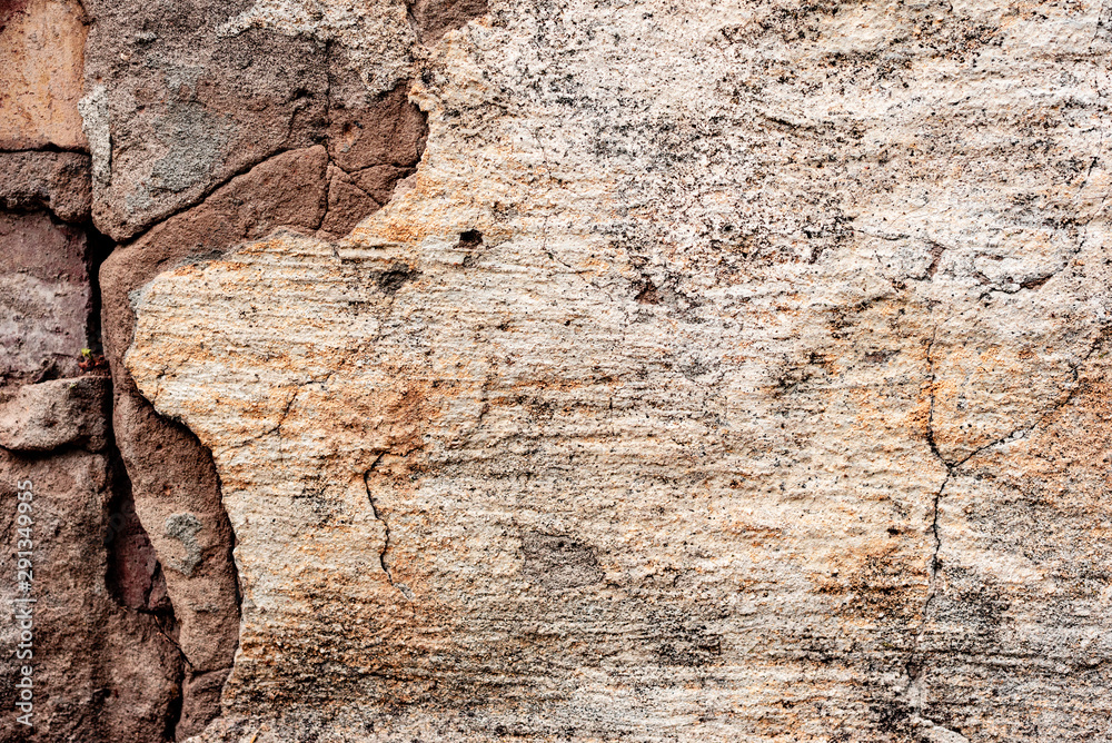 Texture of a concrete wall with cracks and scratches which can be used as a background Texture of a concrete wall with cracks and scratches which can be used as a background