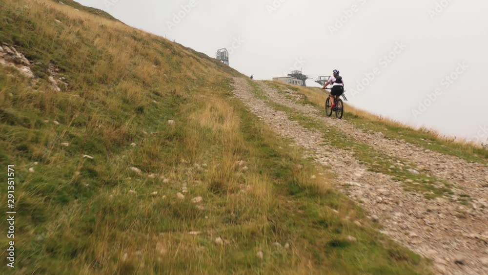 difficult mountain climb and cyclist woman pedaling with tenacity difficult mountain climb and cyclist woman pedaling with tenacity
