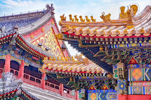 Chinese traditional architecture -  colorful ornament and statue dragons on roof of Lama Temple in Beijing, China photo