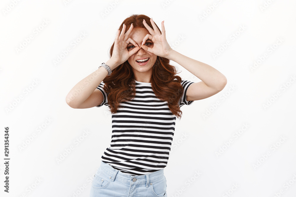 Playful cute young redhead girl in striped t-shirt looking through circles, making finger-glasses and smiling joyfully, tilt head, fool around, do goofy grin as having fun, enjoy summertime holidays Playful cute young redhead girl in striped t-shirt looking through circles, making finger-glasses and smiling joyfully, tilt head, fool around, do goofy grin as having fun, enjoy summertime holidays