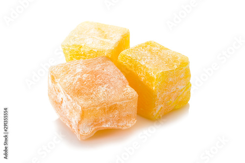 Turkish delight. Honey rahat locum, three pieces of of sweet oriental delights in powered sugar. Close-up view.
