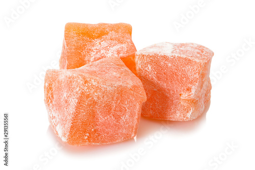 Turkish delight. Pomegranate rahat locum, three pieces of of sweet oriental delights in powered sugar. Close-up view.