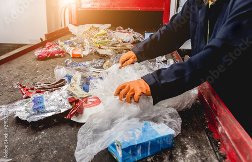 At modern recycling plant. Separate garbage collection. Workers sorting trash to be processed. Trash sorting.