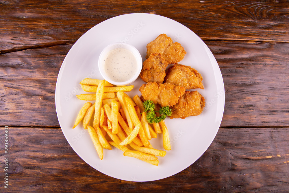 Nuggets chicken breaded with French fries Nuggets chicken breaded with French fries