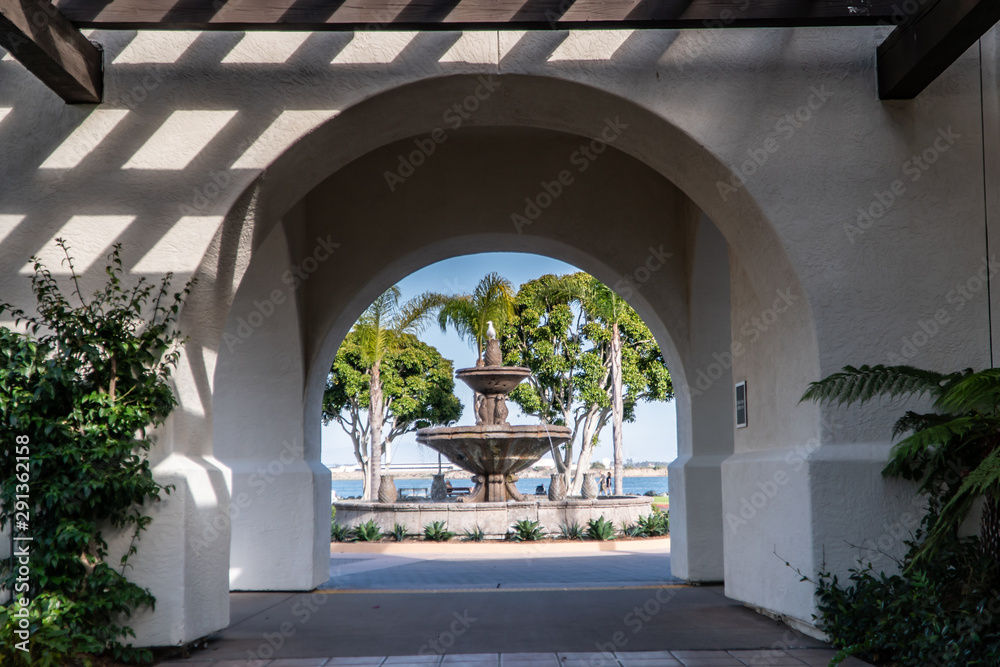Arched walkway with fountain centered at end of walkway.Shelter Island, San Diego.  August 29, 2019