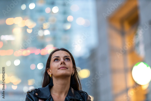 Portrait of young woman in the city at night