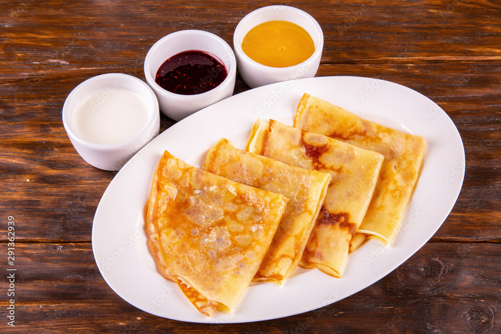 Pancakes with oil and sour cream, jam and honey Pancakes with oil and sour cream, jam and honey