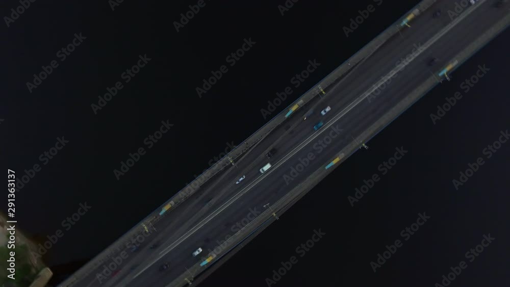 Aerial view car moving on river bridge in city. Car traffic on hanging bridge Aerial view car moving on river bridge in city. Car traffic on hanging bridge