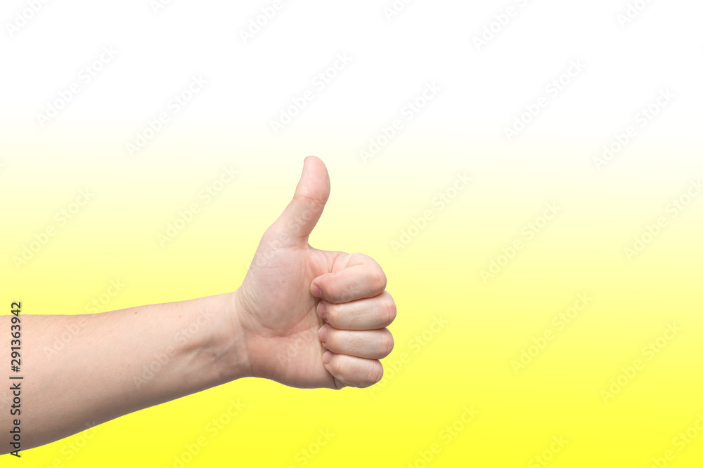 Closeup of male hand showing thumbs up sign