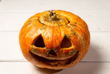 Halloween pumpkin on a wooden table on a background of white boards. Halloween background.