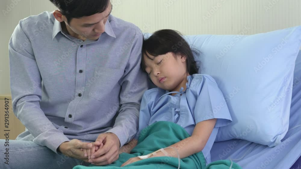 Asian father rub the body patient little girl for reduce the temperature and physical examination at hospital. Concept of family, medical, healthcare and technology. Asian father rub the body patient little girl for reduce the temperature and physical examination at hospital. Concept of family, medical, healthcare and technology.