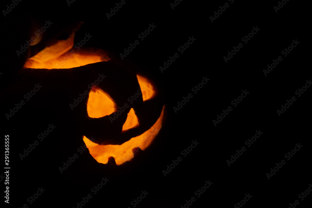 Halloween pumpkin smile and scrary eyes in darkness Halloween pumpkin smile and scrary eyes in darkness
