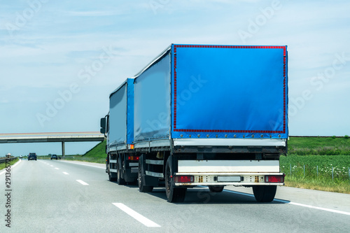 Fototapeta Naklejka Na Ścianę i Meble -  Transportation Truck on summer country highway under blue sky