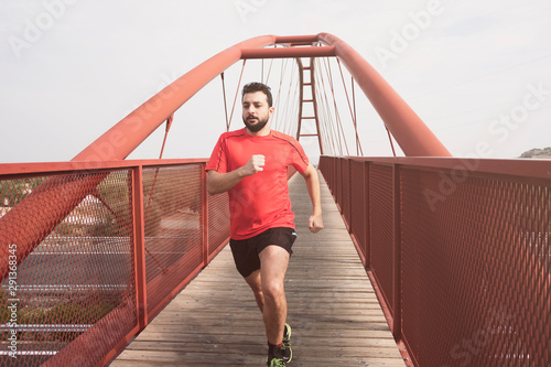 Bearded mid adult man running