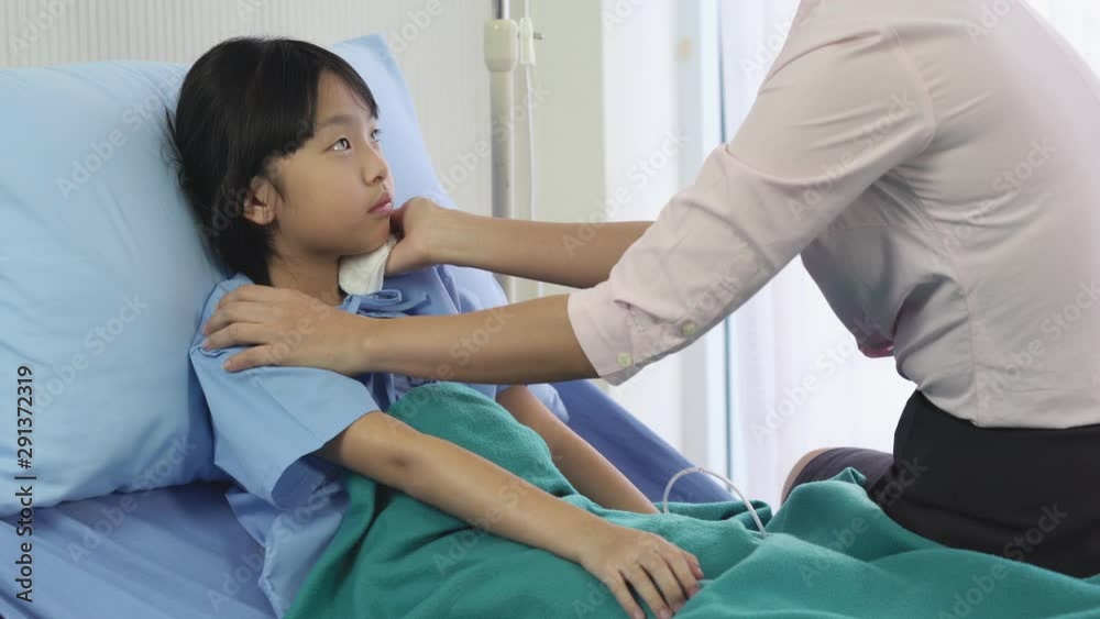 Asian mother rub the body patient little girl for reduce the temperature and physical examination at hospital. Concept of family, medical, healthcare and technology. Asian mother rub the body patient little girl for reduce the temperature and physical examination at hospital. Concept of family, medical, healthcare and technology.