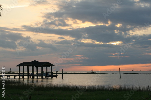 Fototapet Coastal Boathouse at Sunset
