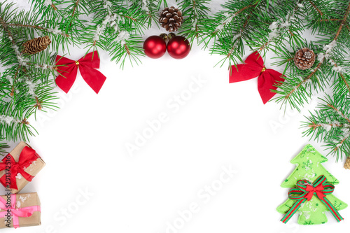 Christmas Frame of Fir tree branch with red bows isolated on white background with copy space for your text
