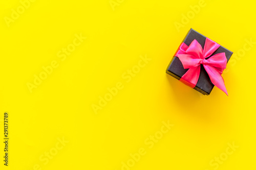 presents in boxes on yellow background top view copyspace