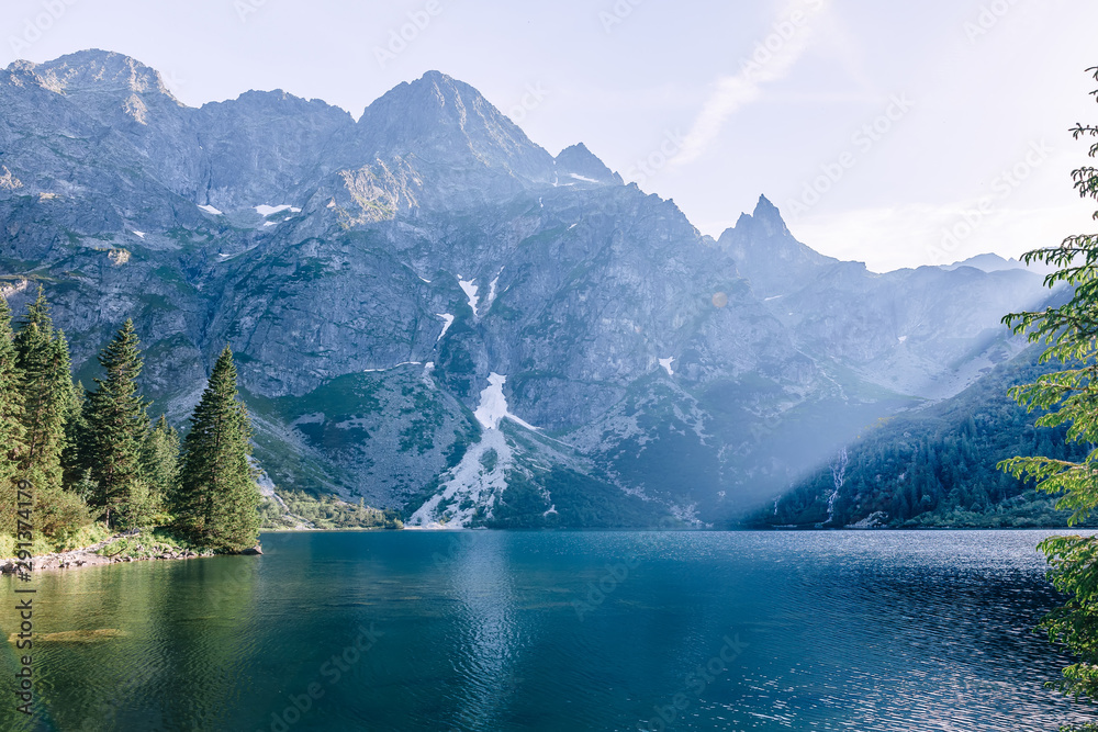 Fototapeta premium Lake in mountains with blue water. rocky peaks of mountains.