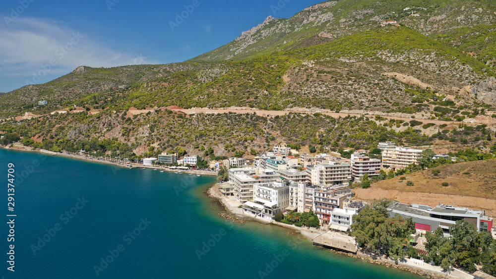 Aerial drone photo of famous seaside area and main town of Loutraki with sandy organised beach with turquoise clear sea and resorts, Greece