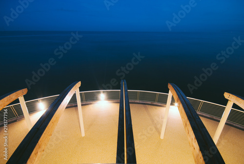 Modern building at the end of a brand new pier photograhed at dusk in tuscany, Italy photo