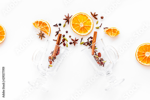 New Year beverage. Ingredients for mulled wine in glasses on white background top view copy space