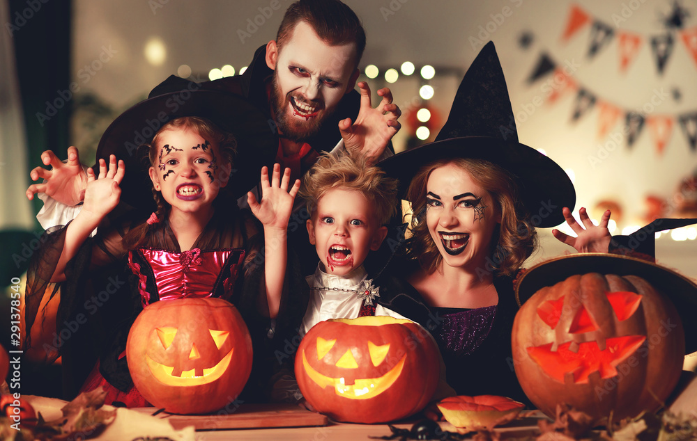 Fototapeta premium happy family mother father and children in costumes and makeup on Halloween.
