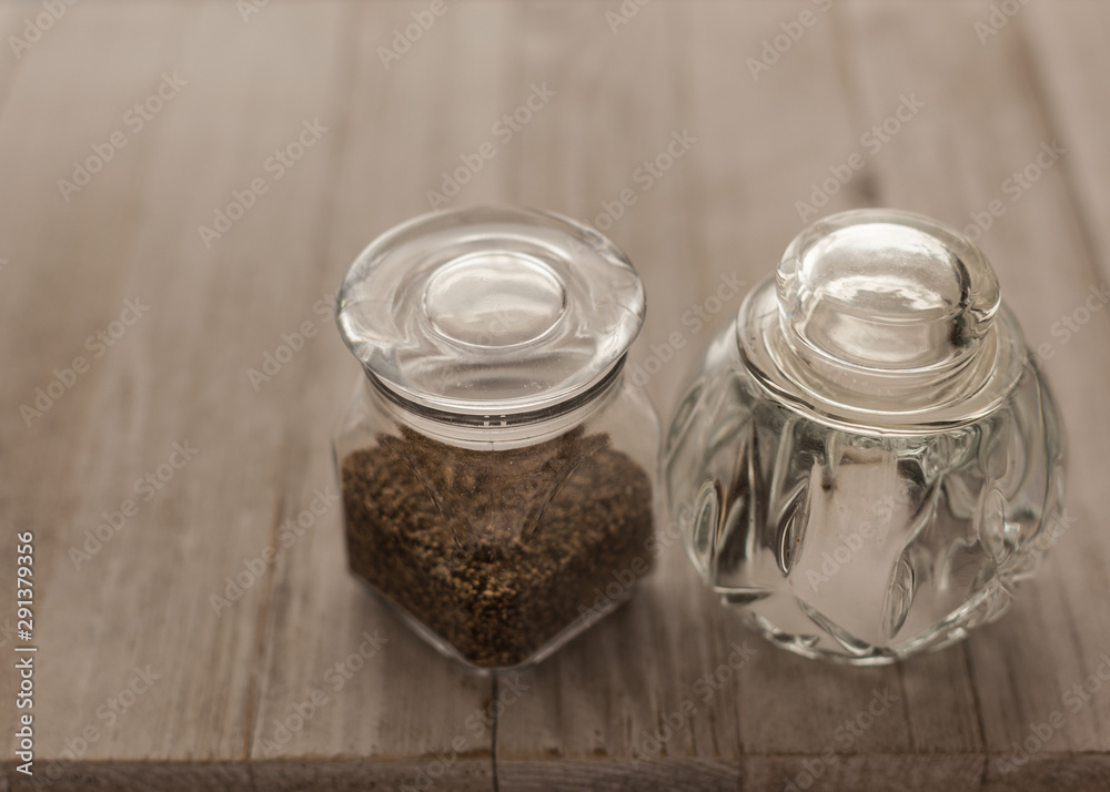 salt and pepper on the wood rustic table salt and pepper on the wood rustic table
