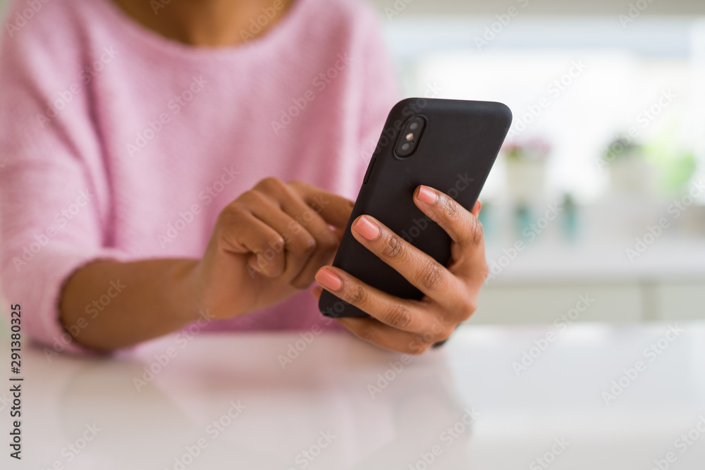 Close up of african american woman using smartphone and smiling