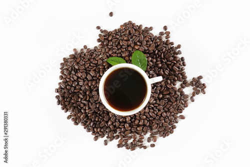 brown roasted coffee beans and coffee cup
