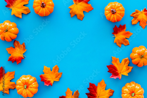 Photography Autumn background with leaves and pumpkins on blue top view space for text frame