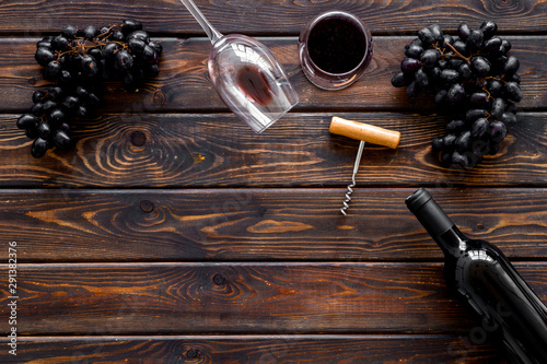 Open wine bottle. Top view dark wooden background copy space