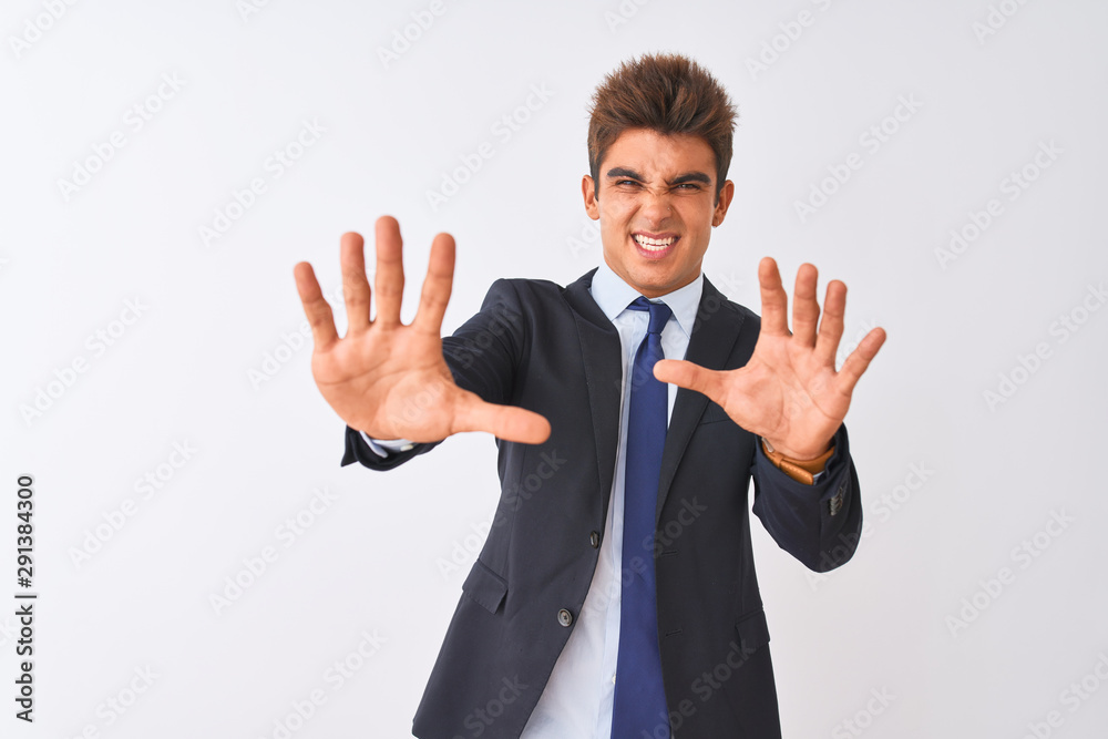 Young handsome businessman wearing suit standing over isolated white background afraid and terrified with fear expression stop gesture with hands, shouting in shock. Panic concept. Young handsome businessman wearing suit standing over isolated white background afraid and terrified with fear expression stop gesture with hands, shouting in shock. Panic concept.